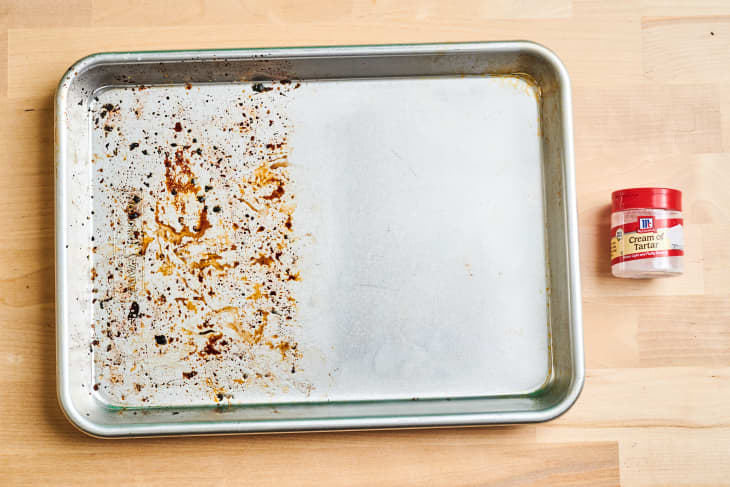 Half cleaned baking sheet with cream of tartar