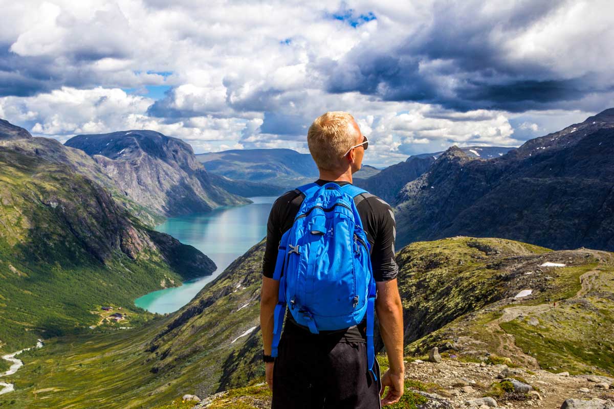 How to choose the best hiking backpack: hiker wearing blue day pack