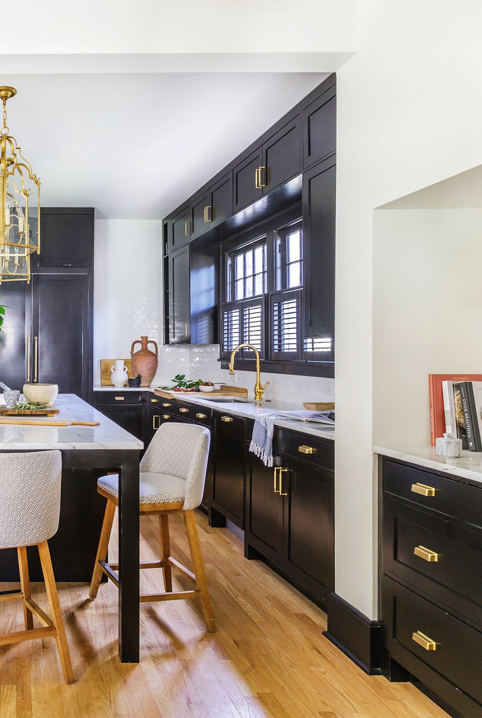 kitchen with black cabinets with gold hardware